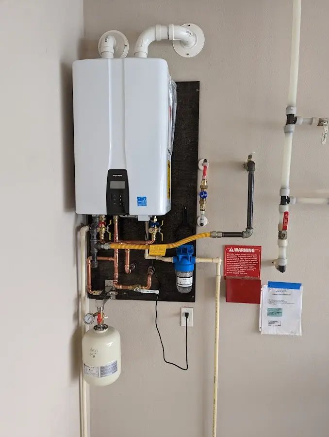 Professional plumber installing copper piping in a Hollister home